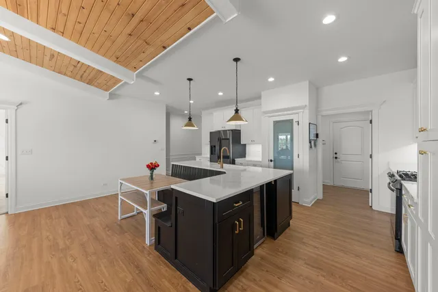 a kitchen with a sink and wooden floor