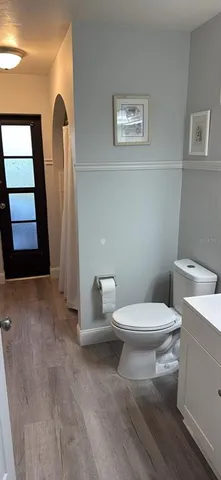 a white toilet sitting next to a bathroom sink