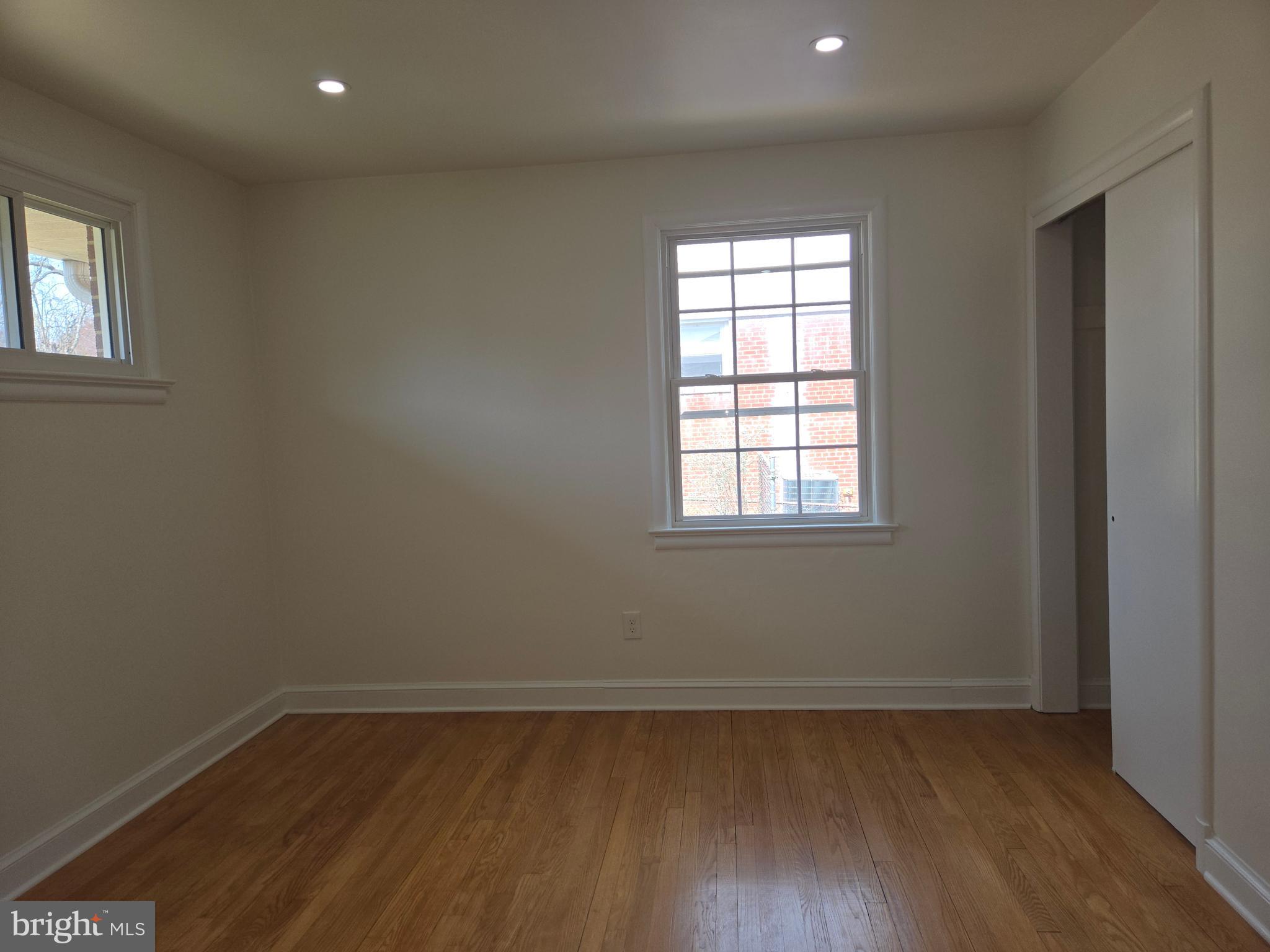 10500 Glenhaven Drive Silver Spring, MD 20902 - Photo 11 of 21 an empty room with wooden floor and windows