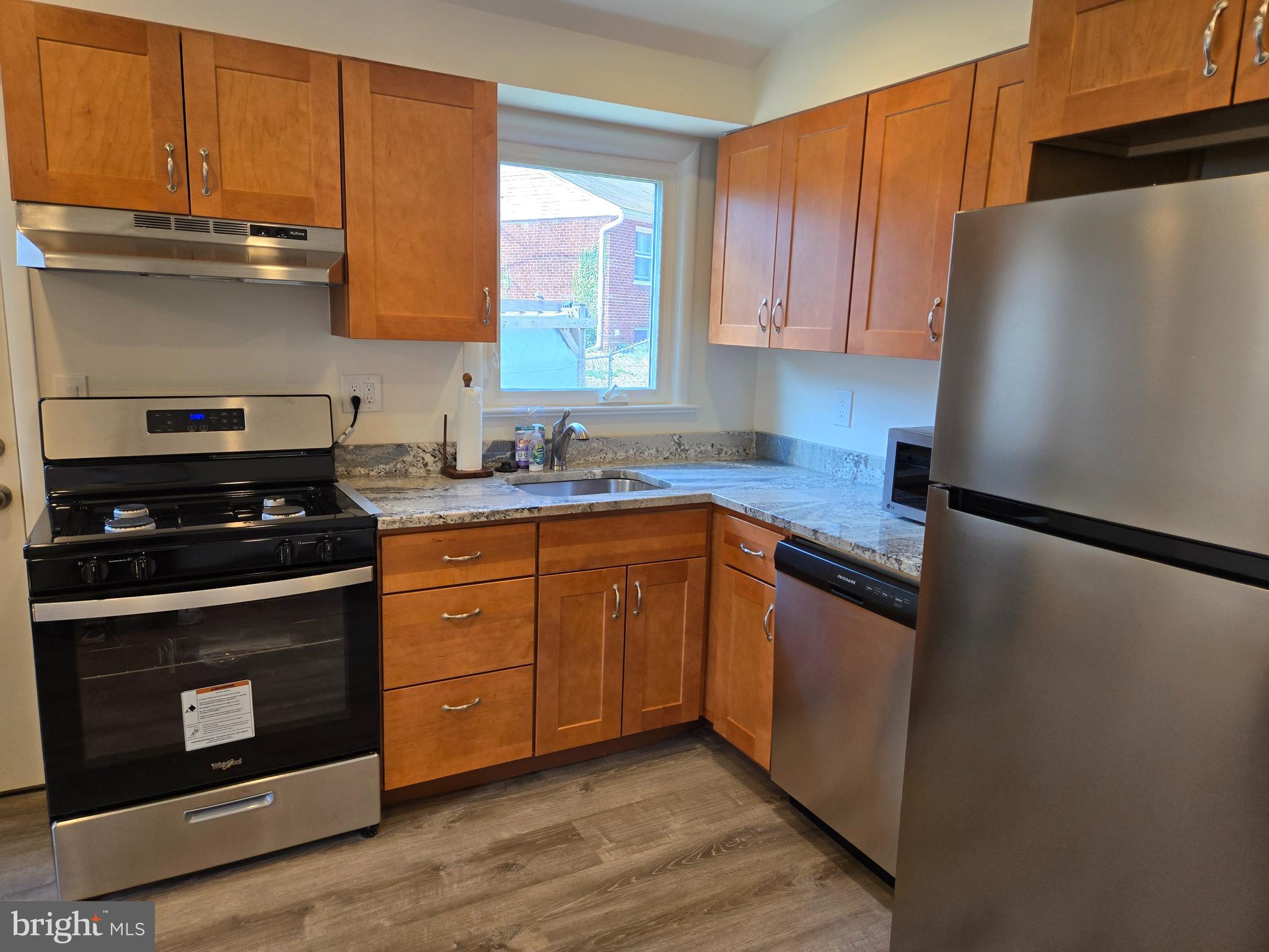 10500 Glenhaven Drive Silver Spring, MD 20902 - Photo 3 of 21 a kitchen with stainless steel appliances a stove a sink and a refrigerator