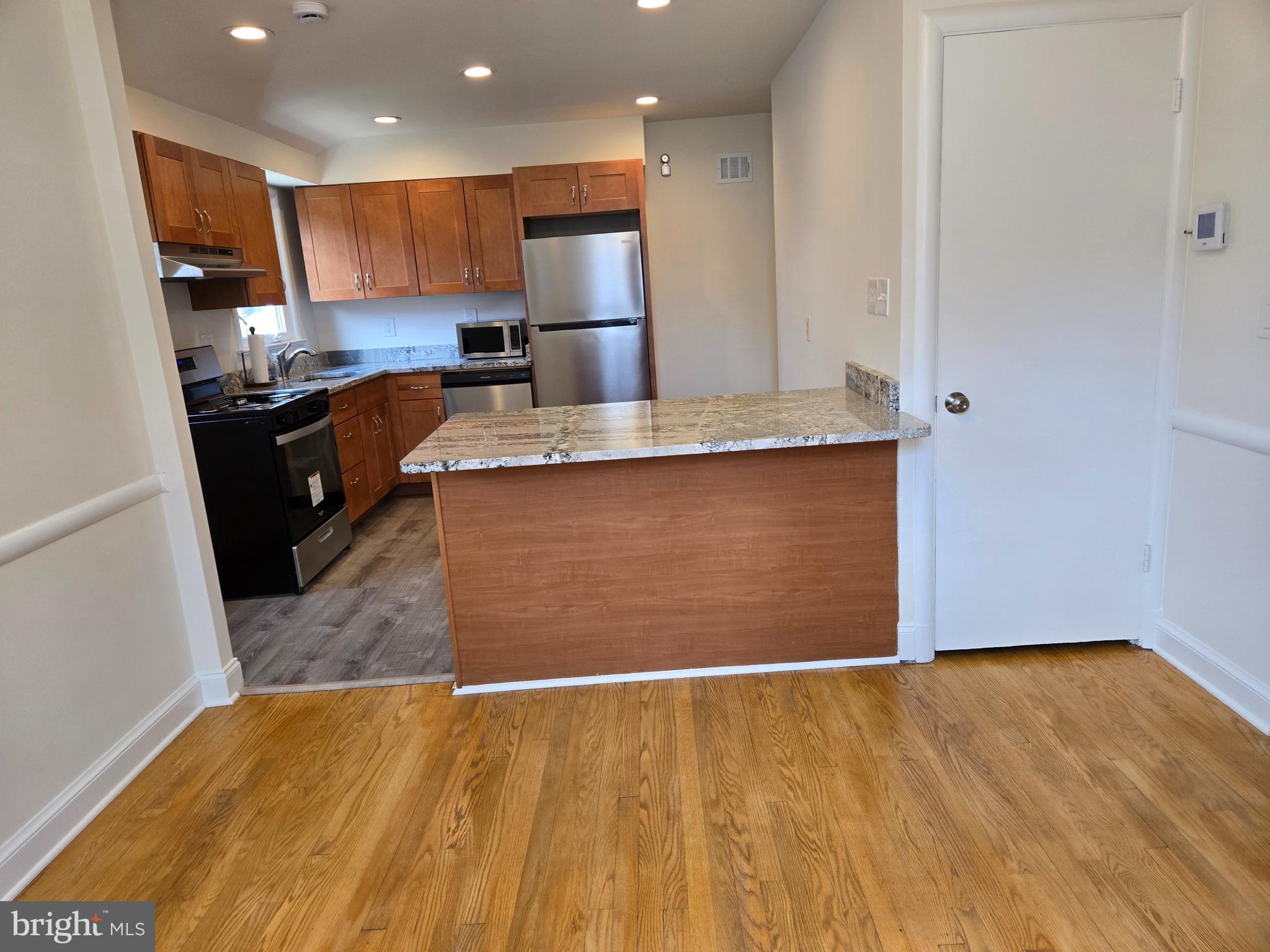 10500 Glenhaven Drive Silver Spring, MD 20902 - Photo 5 of 21 a kitchen with stainless steel appliances granite countertop a sink a stove and a refrigerator