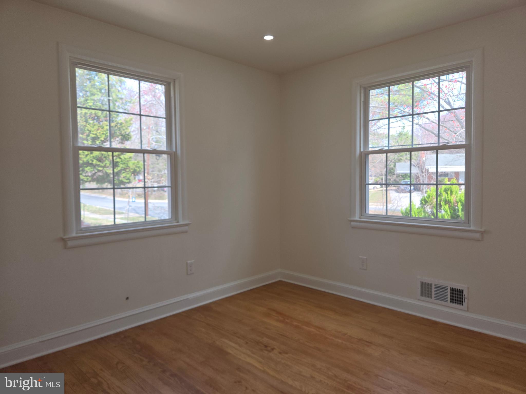 10500 Glenhaven Drive Silver Spring, MD 20902 - Photo 10 of 21 an empty room with wooden floor and windows