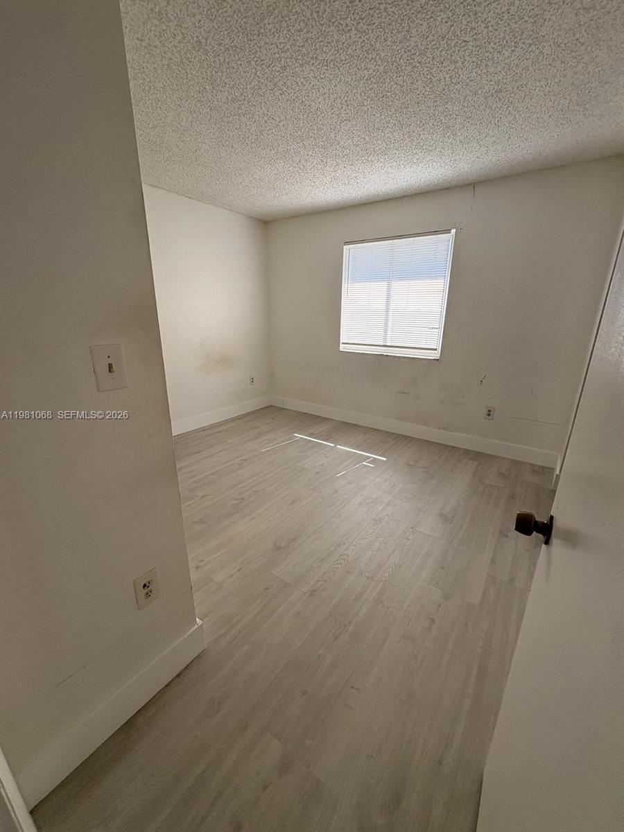 15231 Southwest 80th Street, Unit 615 Miami, FL 33193 - Photo 3 of 3 an empty room with a workbench