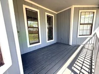 a view of an entryway with wooden floor and door