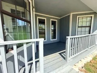 a view of deck with a large window and wooden fence