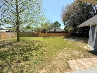 a swimming pool with outdoor seating and yard