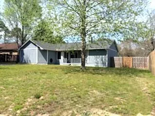 a front view of house with yard space and swimming pool