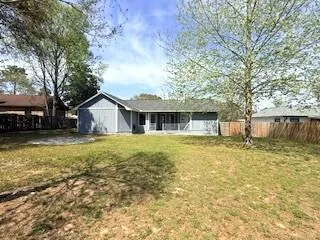 a view of a house with backyard and a garden