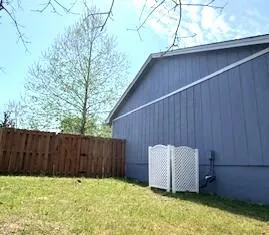 a front view of a house with a garden and trees