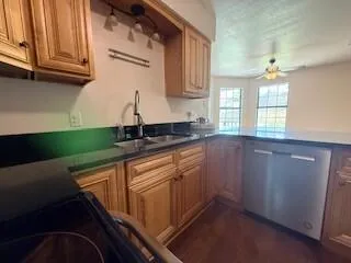 a kitchen with granite countertop a sink and cabinets