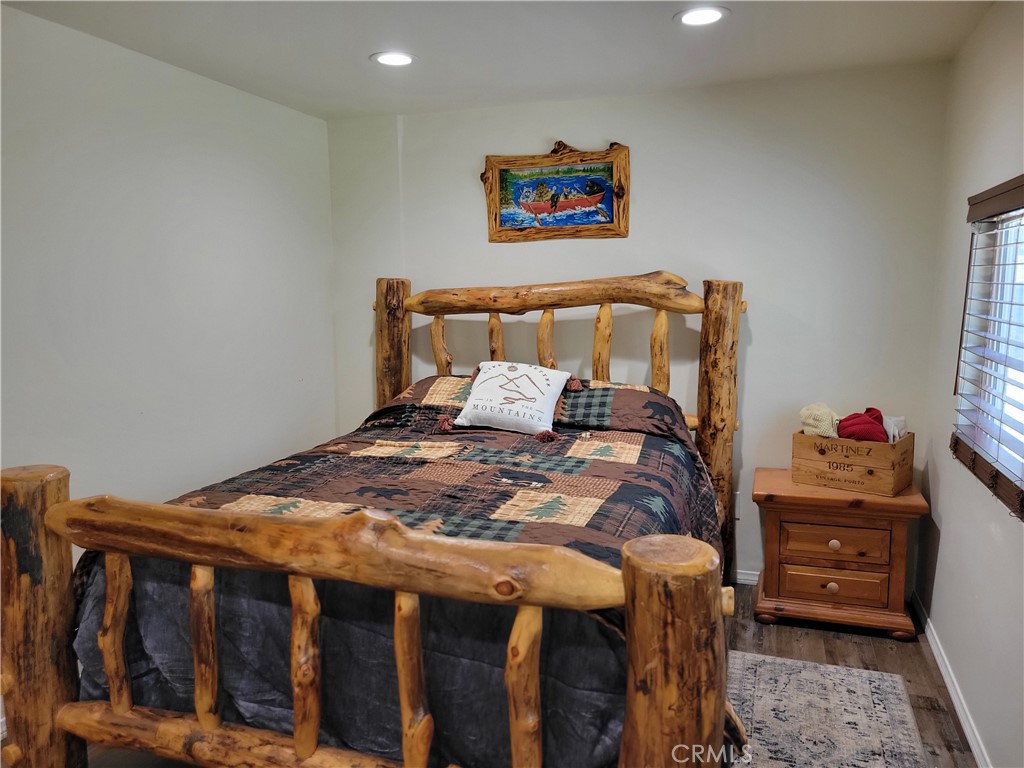 1116 Lark Road Wrightwood, CA 92397 - Photo 23 of 46 a bedroom with bed and wooden floor