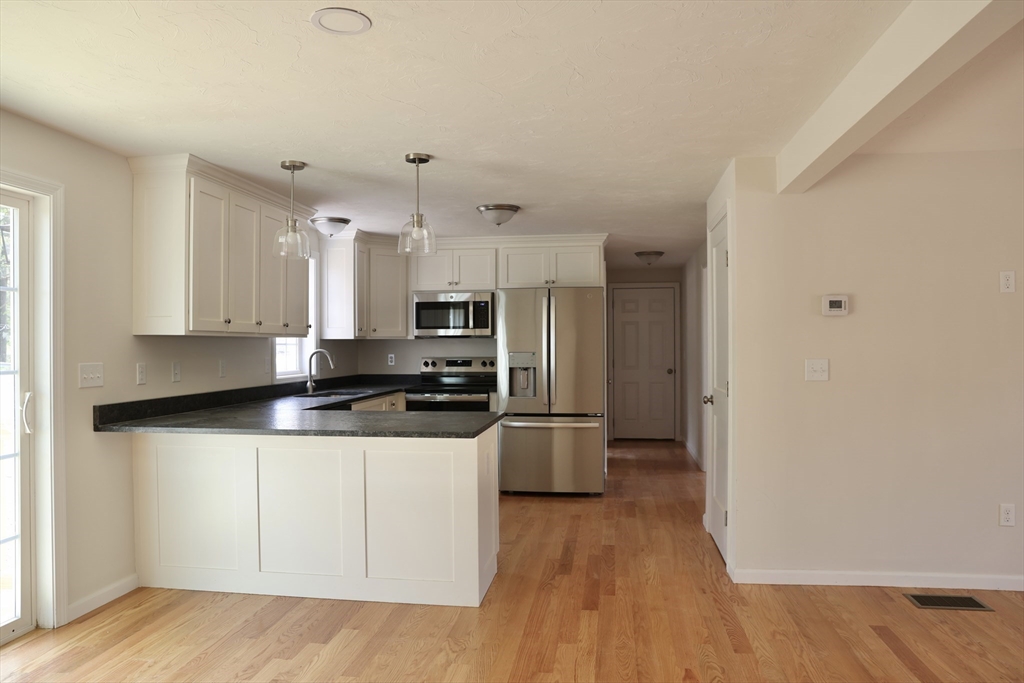 1 A Dudley Road Townsend, MA 01469 - Photo 4 of 17 a kitchen with stainless steel appliances a sink a stove a refrigerator and cabinets
