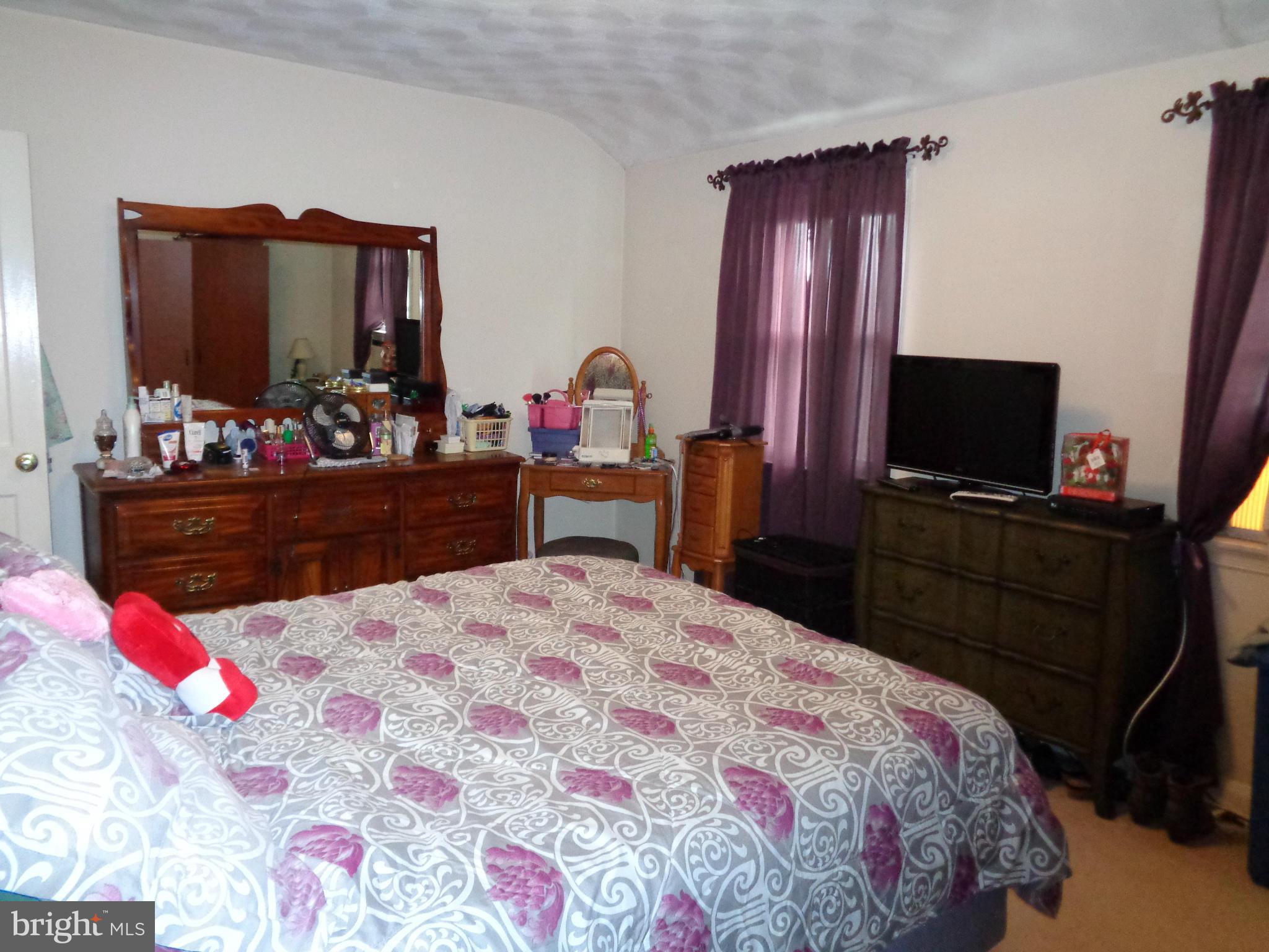 8374 Kavanagh Road Baltimore, MD 21222 - Photo 11 of 24 a bedroom with a bed and flat screen tv
