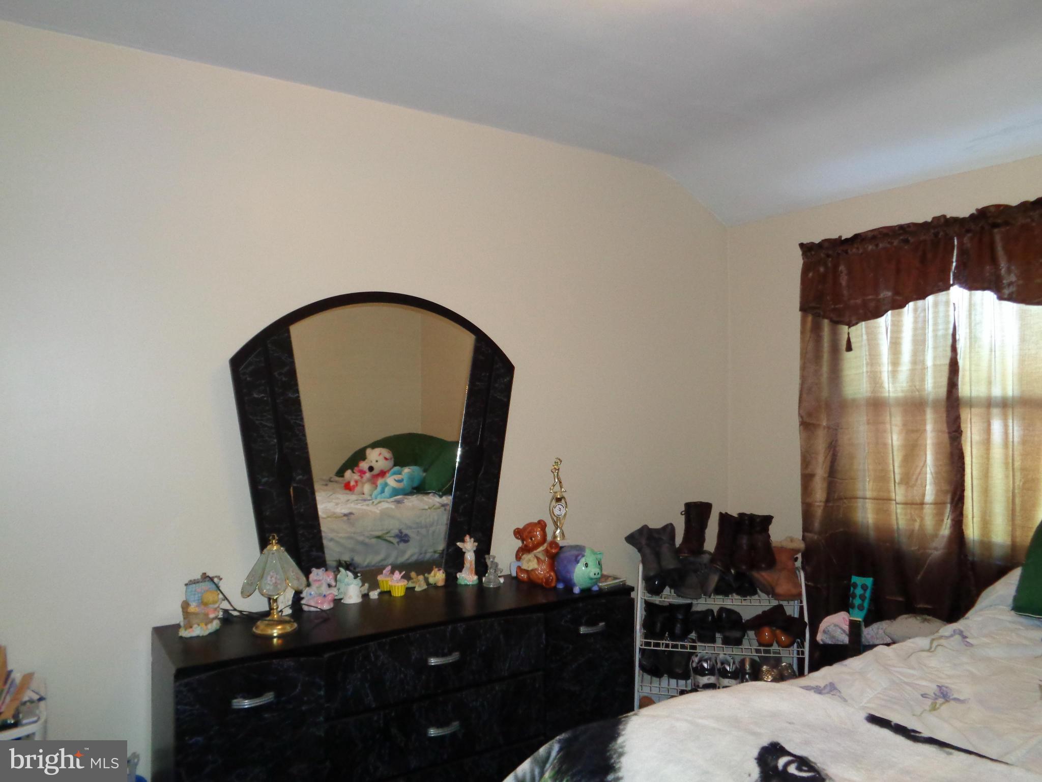 8374 Kavanagh Road Baltimore, MD 21222 - Photo 13 of 24 a bedroom with a bed and a dresser