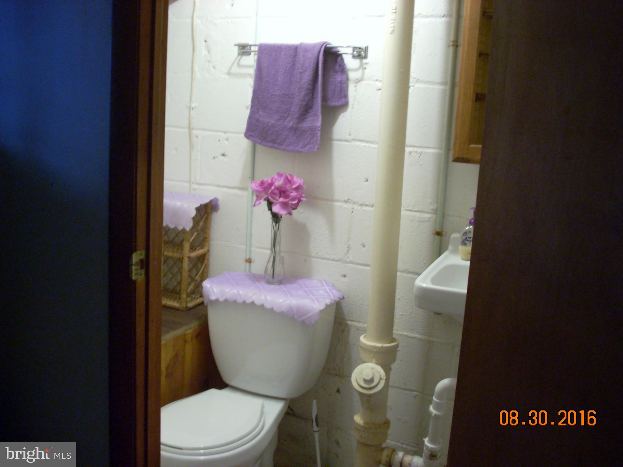 8374 Kavanagh Road Baltimore, MD 21222 - Photo 16 of 24 a bathroom with a sink and toilet