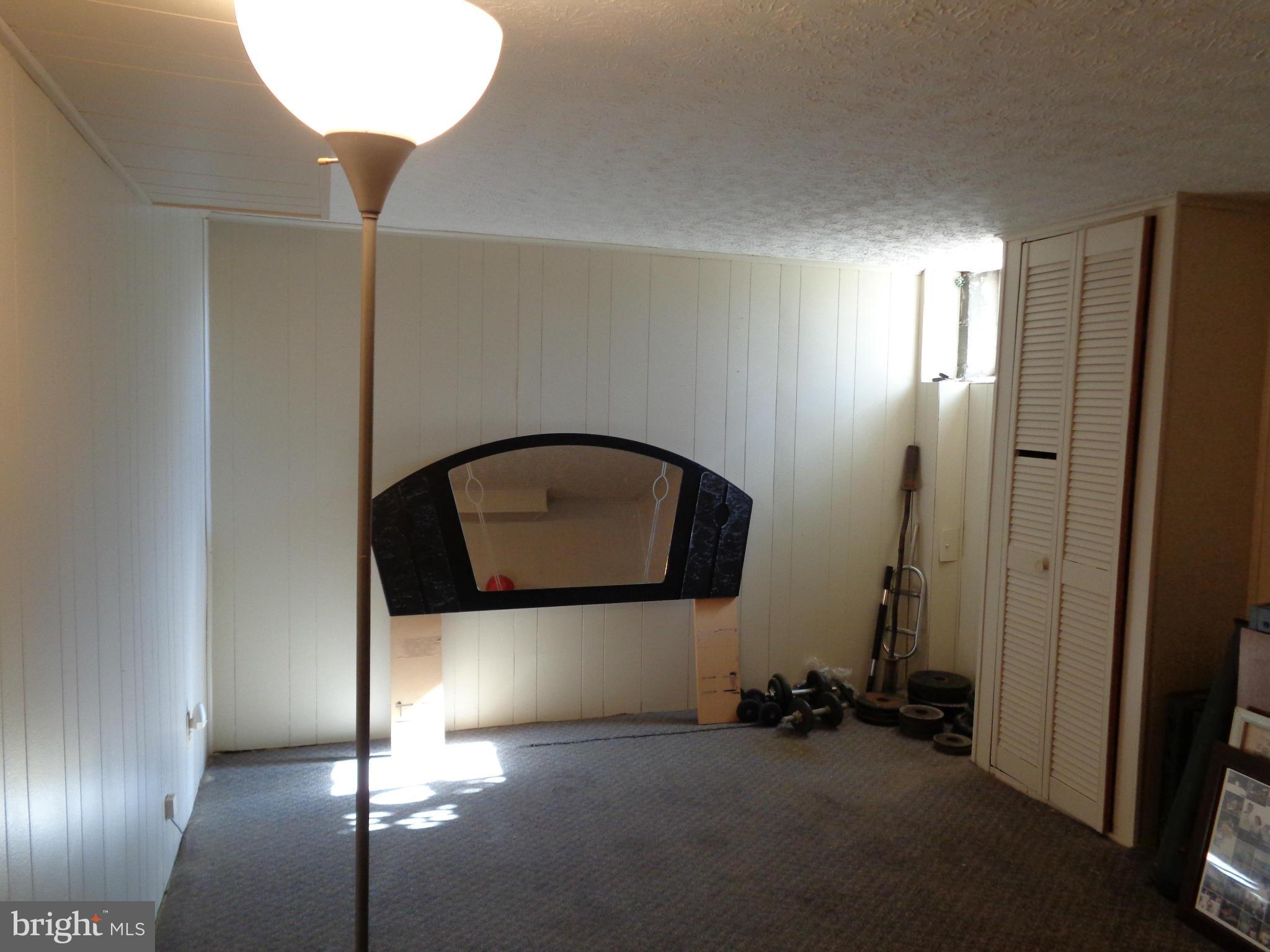 8374 Kavanagh Road Baltimore, MD 21222 - Photo 17 of 24 a room with a mirror and a wooden door