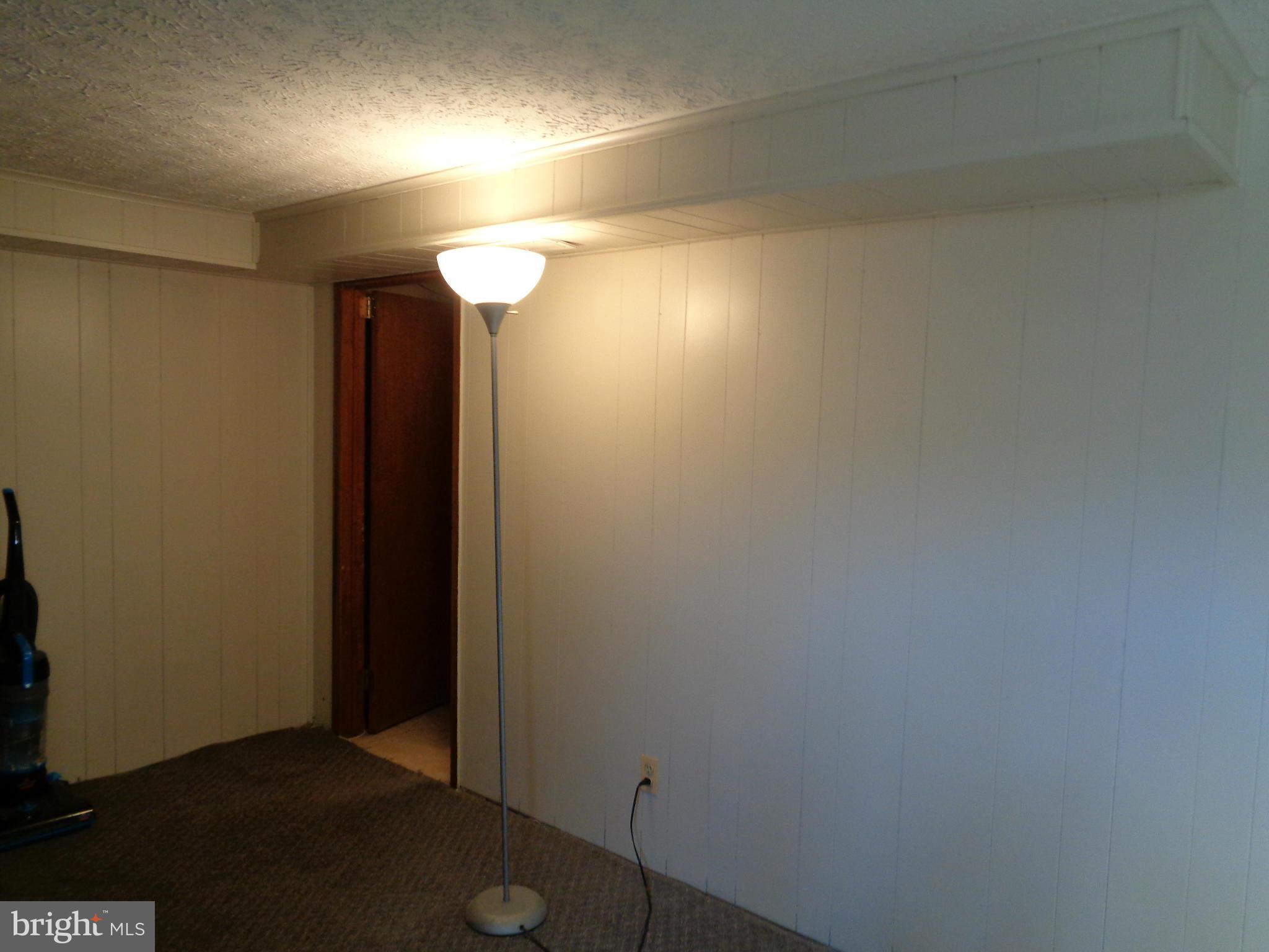 8374 Kavanagh Road Baltimore, MD 21222 - Photo 18 of 24 an empty room with wooden floor and windows