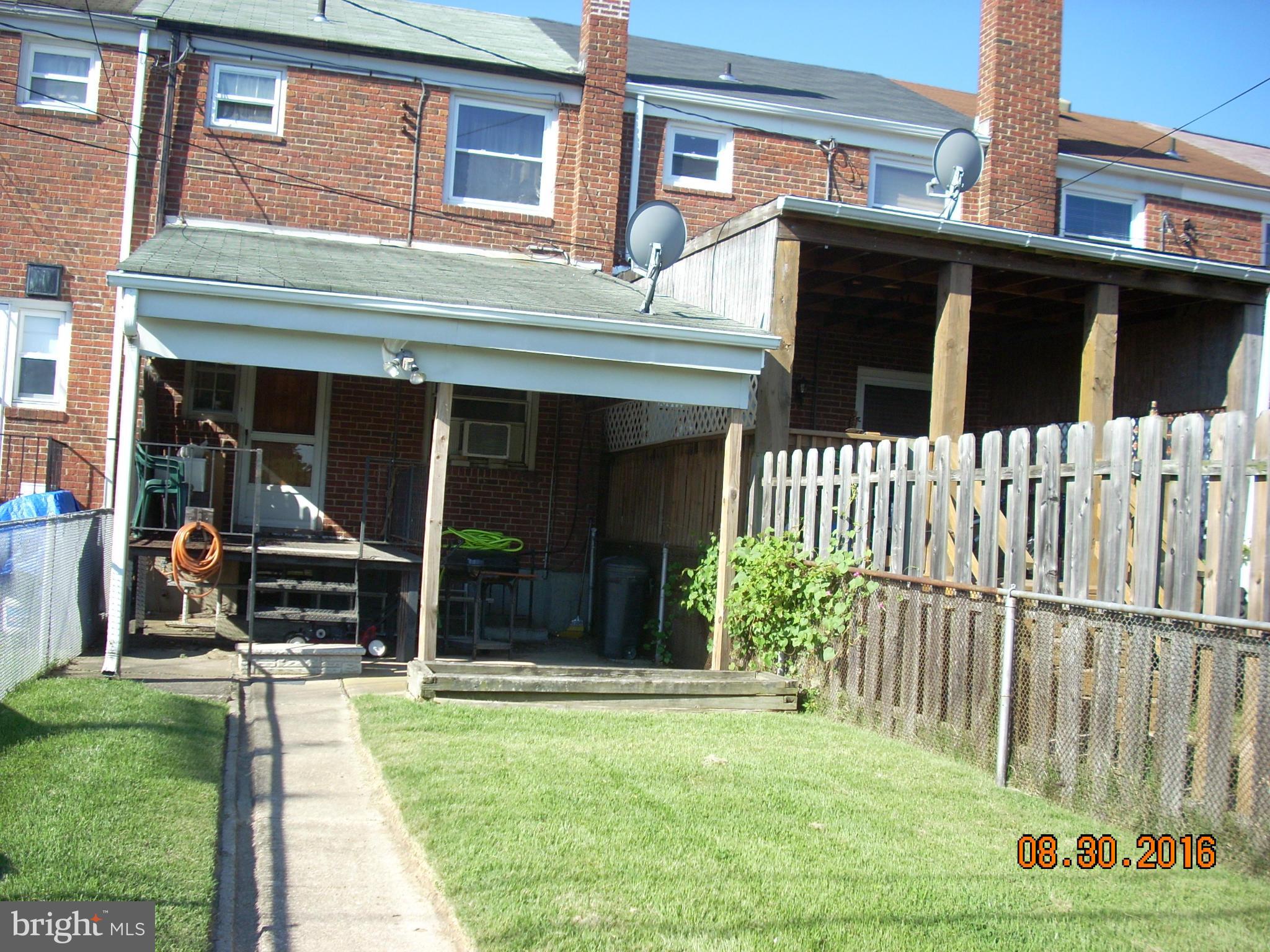 8374 Kavanagh Road Baltimore, MD 21222 - Photo 19 of 24 a front view of a house with a yard