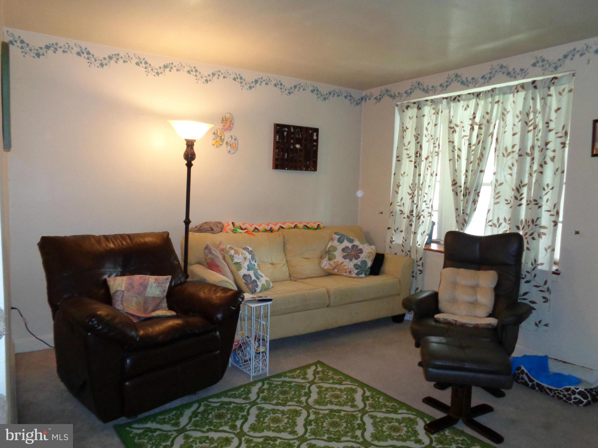 8374 Kavanagh Road Baltimore, MD 21222 - Photo 3 of 24 a living room with furniture and a flat screen tv