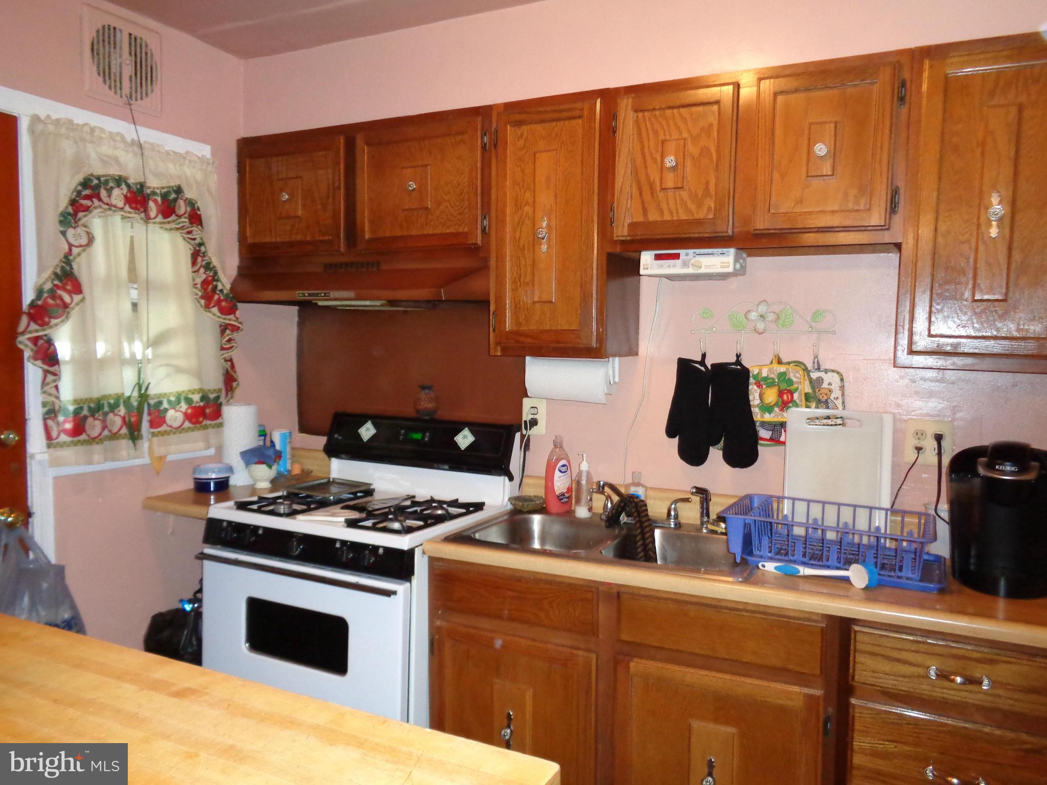 8374 Kavanagh Road Baltimore, MD 21222 - Photo 7 of 24 a kitchen with stainless steel appliances granite countertop a sink stove and cabinets