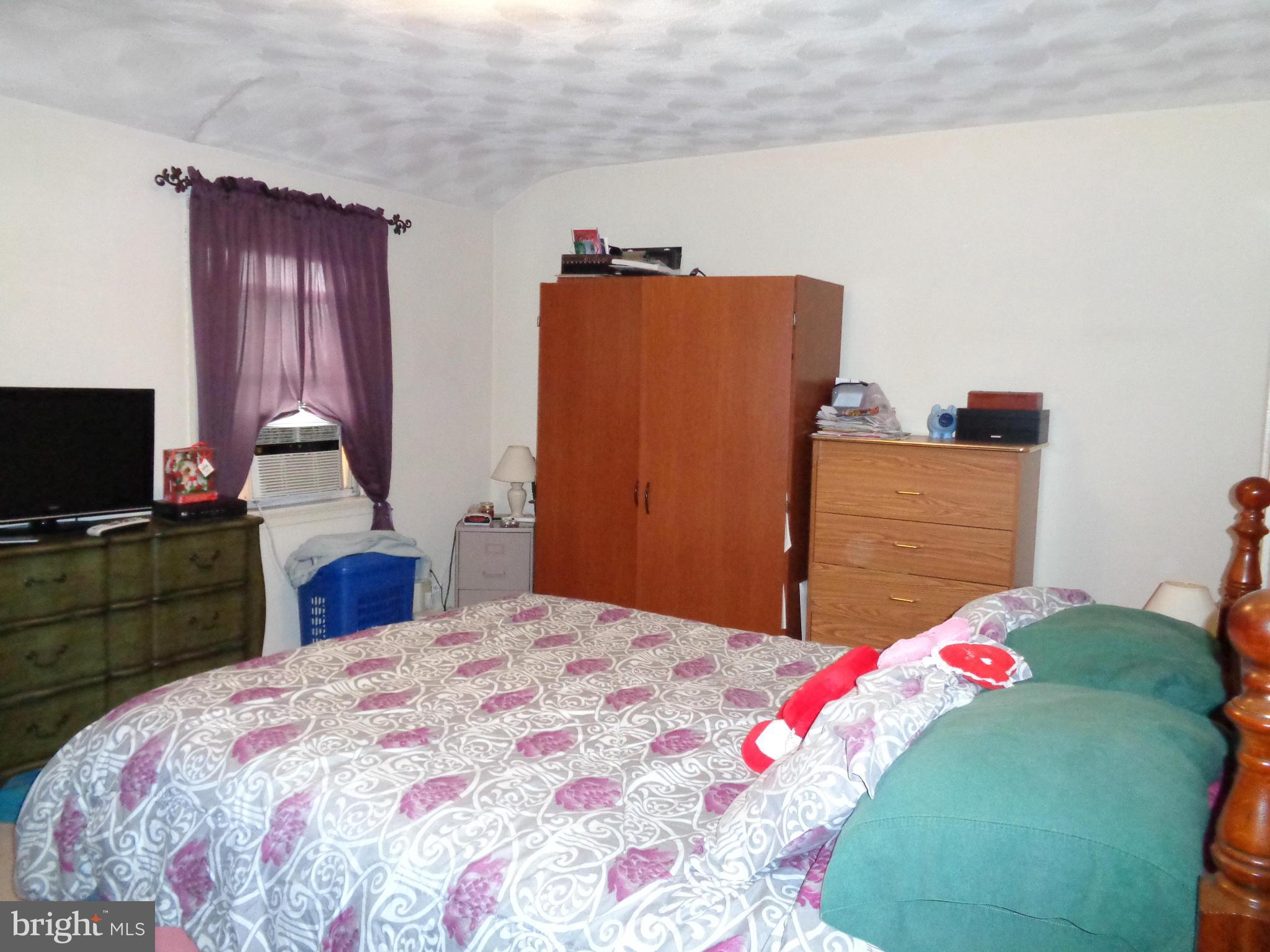 8374 Kavanagh Road Baltimore, MD 21222 - Photo 10 of 24 a bedroom with a bed and a television