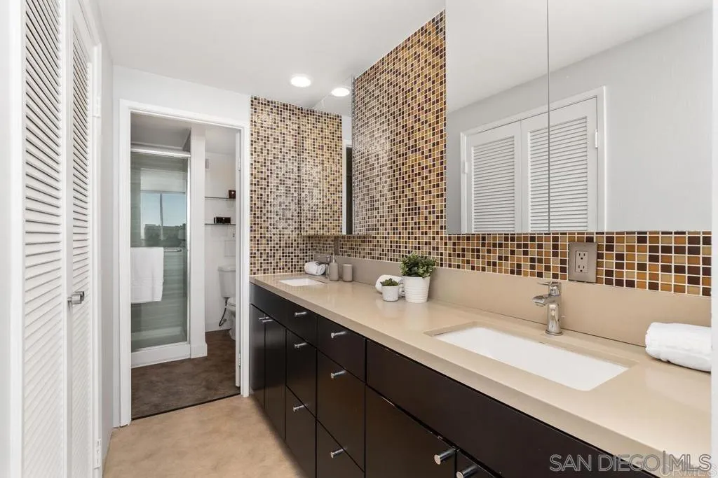2500 Torrey Pines Road, Unit 402 La Jolla, CA 92037 - Photo 5 of 21 a bathroom with a double vanity sink and mirror