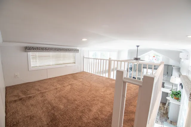 a view of a livingroom with wooden floor and a window