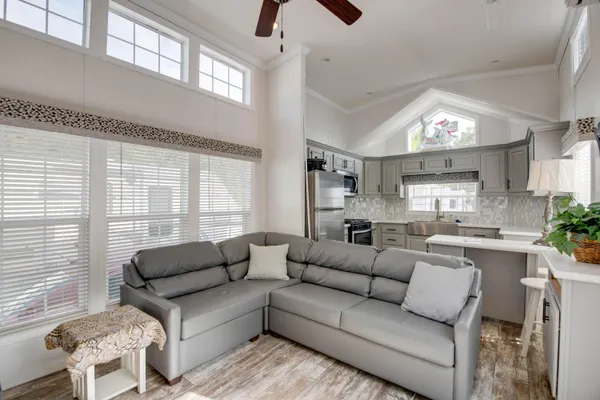 a kitchen with white cabinets and sink