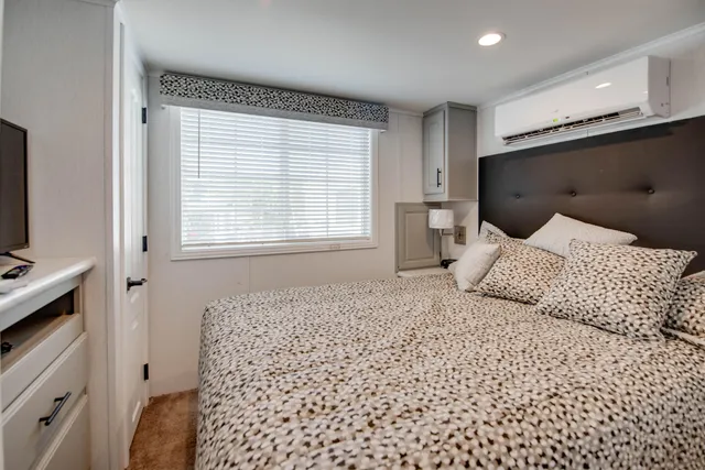 a living room with a flat screen tv and white walls
