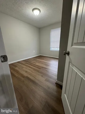 en empty room with wooden floor