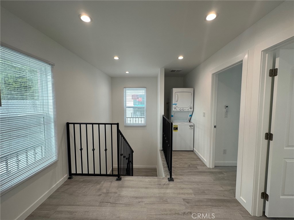 7012 Bertrand Avenue Reseda, CA 91335 - Photo 15 of 23 a view of a hallway with wooden floor and windows
