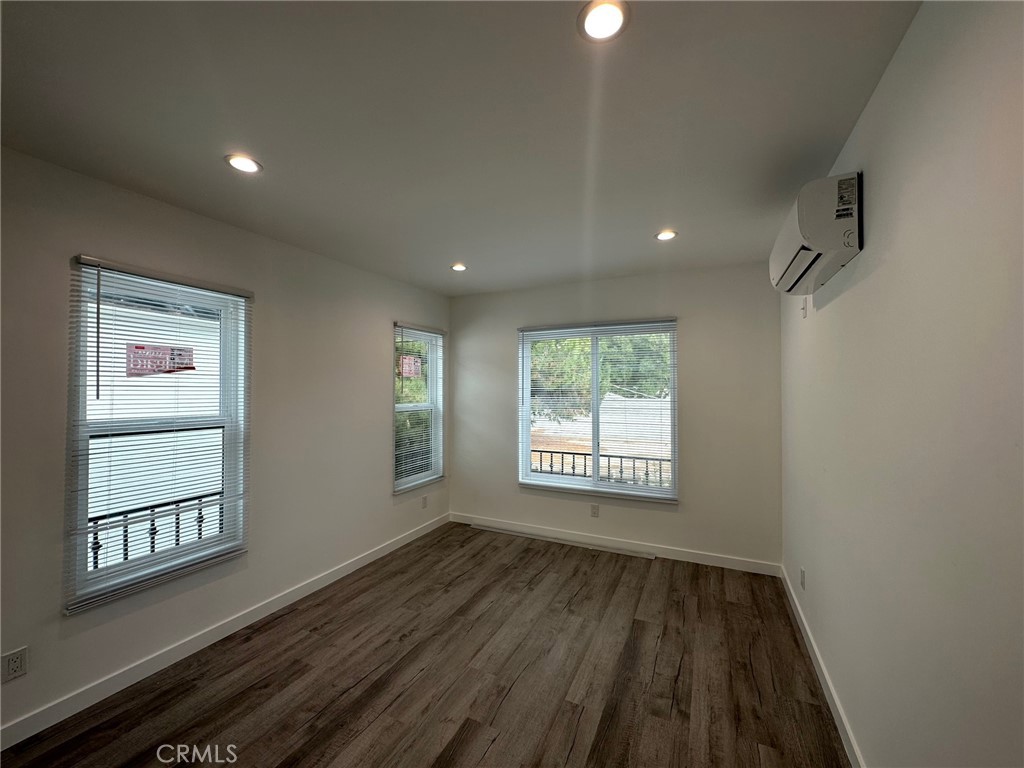 7012 Bertrand Avenue Reseda, CA 91335 - Photo 16 of 23 a view of an empty room with wooden floor and a window