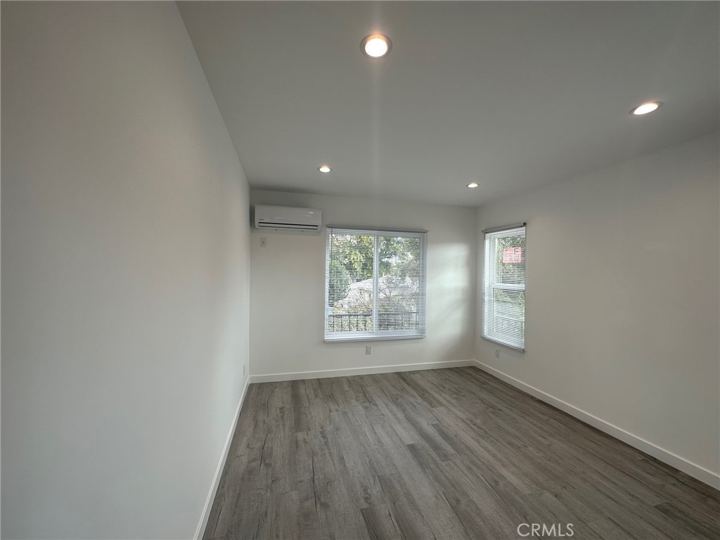 7012 Bertrand Avenue Reseda, CA 91335 - Photo 19 of 23 an empty room with wooden floor and windows