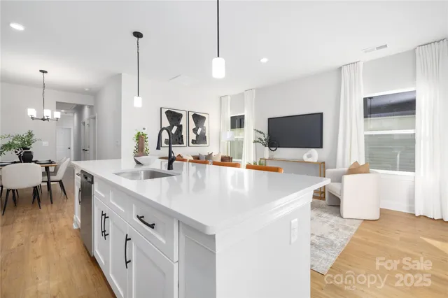 a large kitchen with kitchen island a sink appliances and a dining table