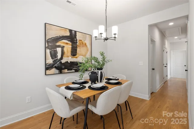 a dining room with furniture and wooden floor