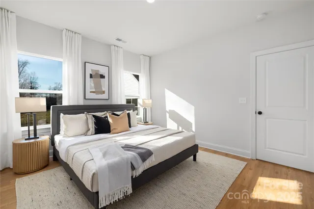 a bedroom with a bed and large window