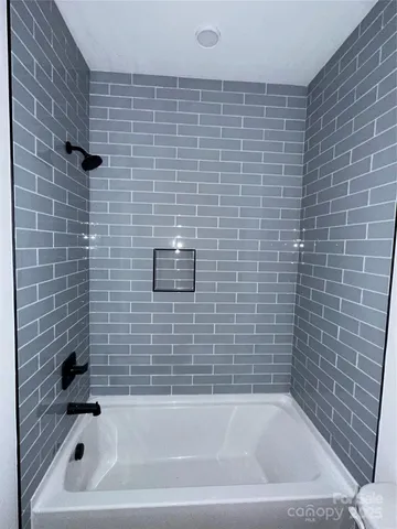 a kitchen with stainless steel appliances granite countertop a sink a counter and chairs