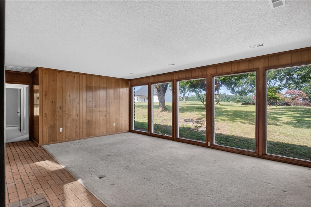 1412 Simpson Road Pendleton, SC 29670 - Photo 4 of 48 A spacious room offers panoramic views of the verdant outdoor landscape through multiple large windows.
