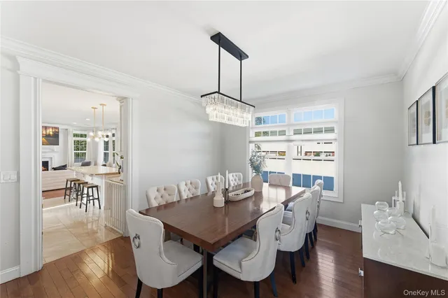 a view of a dining room with furniture wooden floor and chandelier