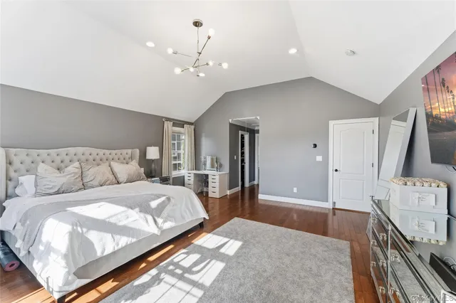 a spacious bedroom with a large bed and a dresser