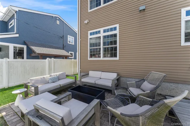 a view of a patio with couple of chairs and a couch