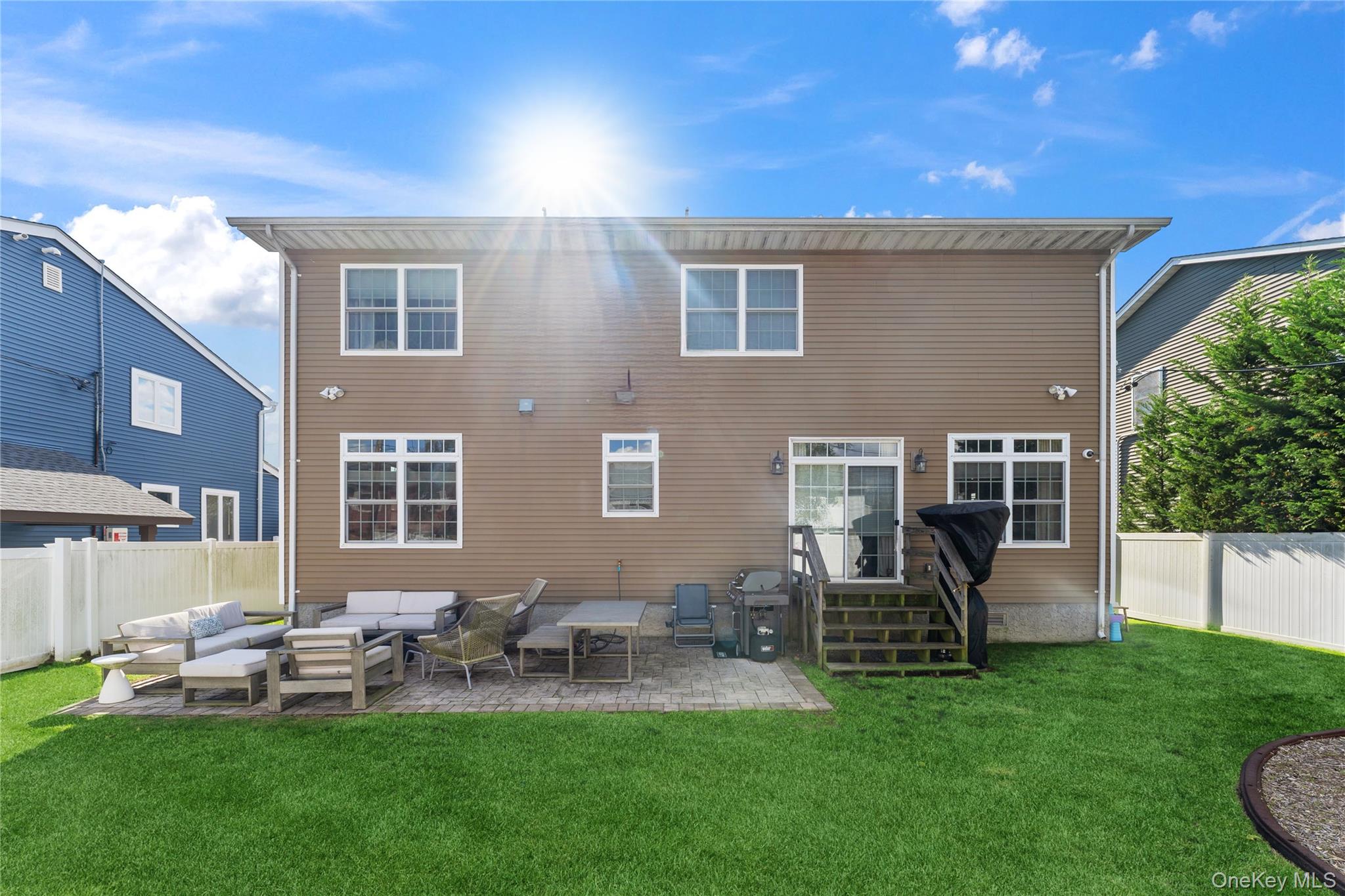 3483 Frederick Street Oceanside, NY 11572 - Photo 33 of 34 a view of a house with backyard sitting area and garden
