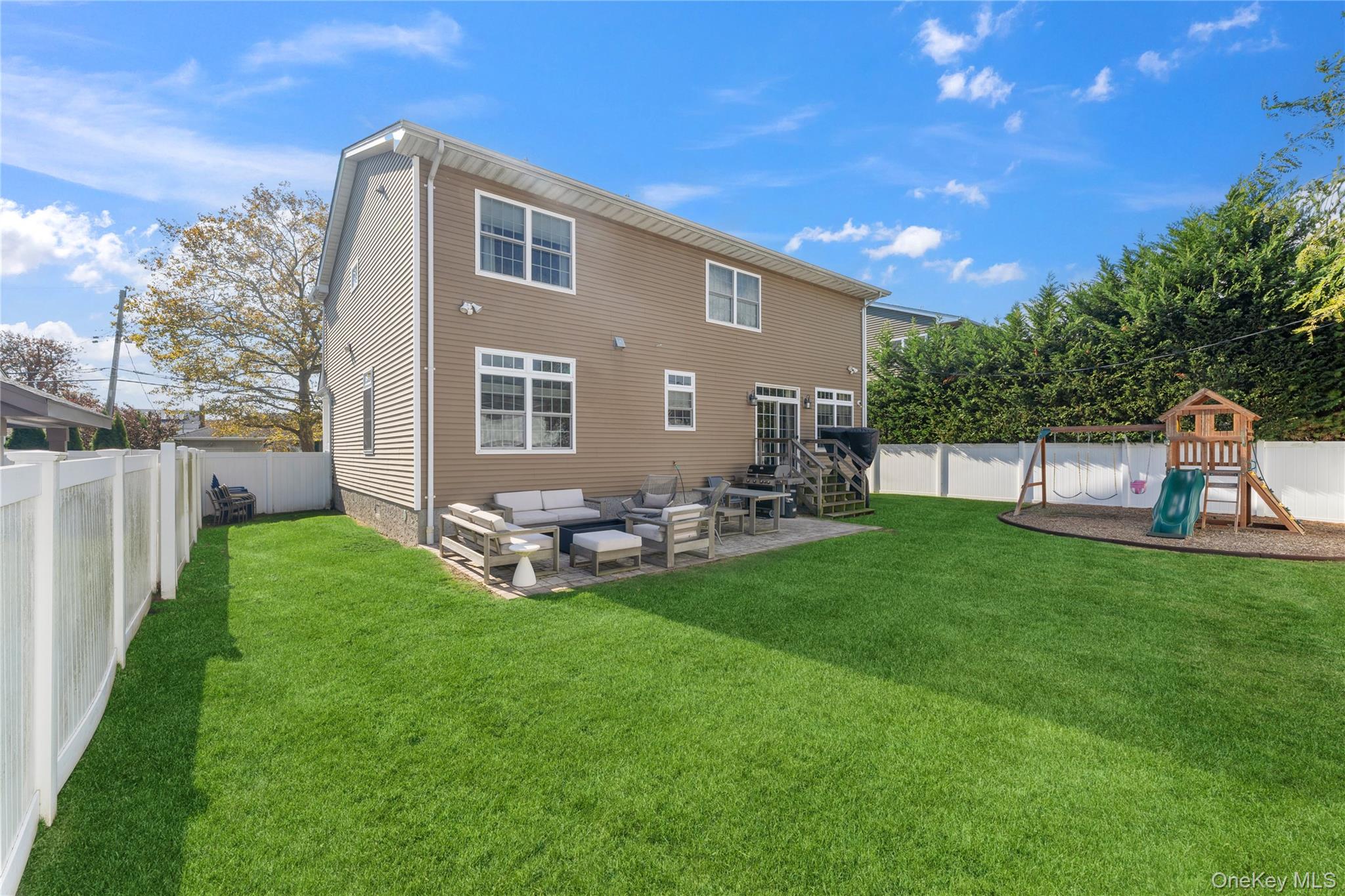 3483 Frederick Street Oceanside, NY 11572 - Photo 34 of 34 a view of a house with backyard and sitting area