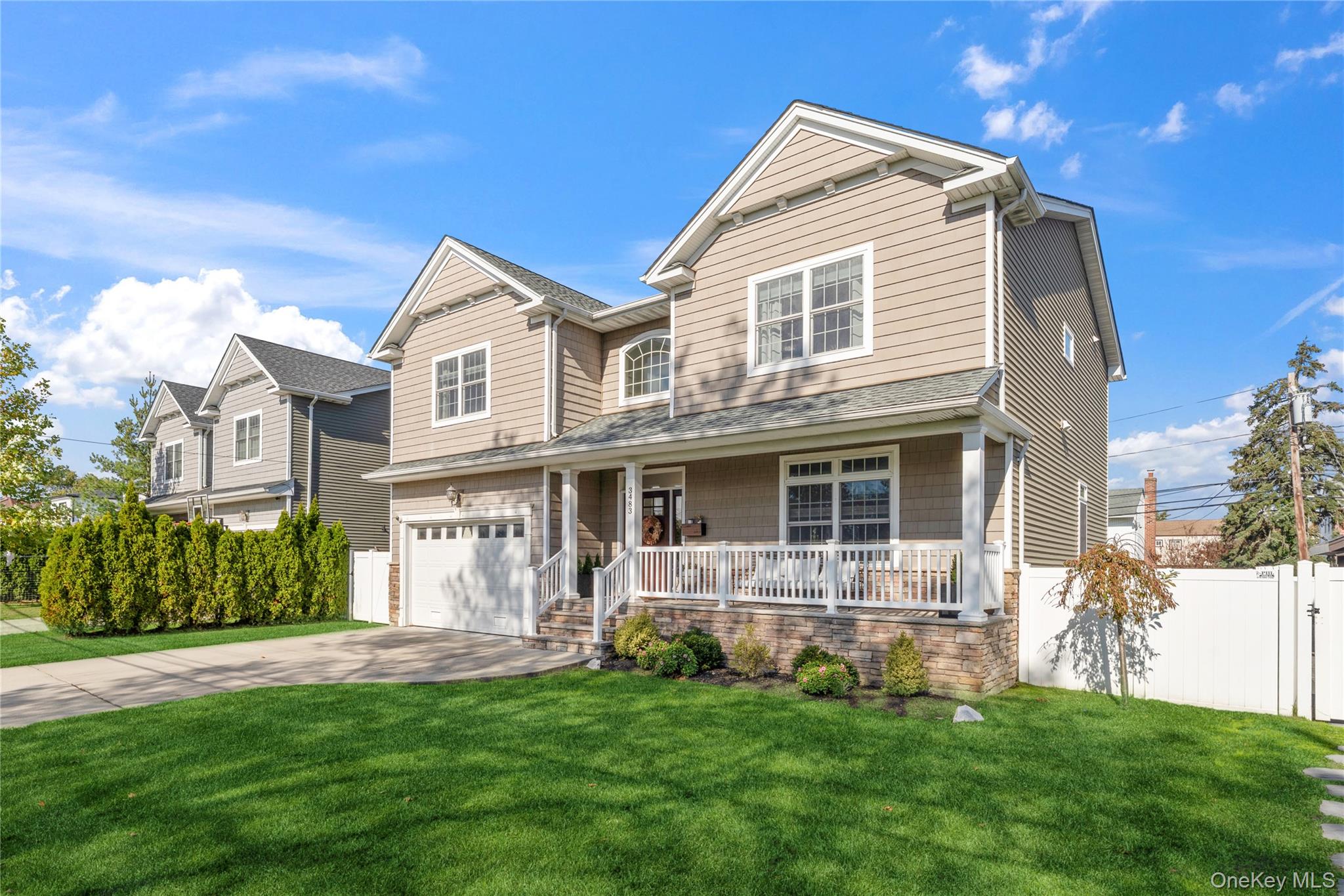 3483 Frederick Street Oceanside, NY 11572 - Photo 4 of 34 a front view of a house with a yard