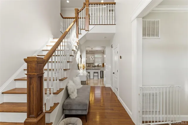 a view of entryway and hall with wooden floor