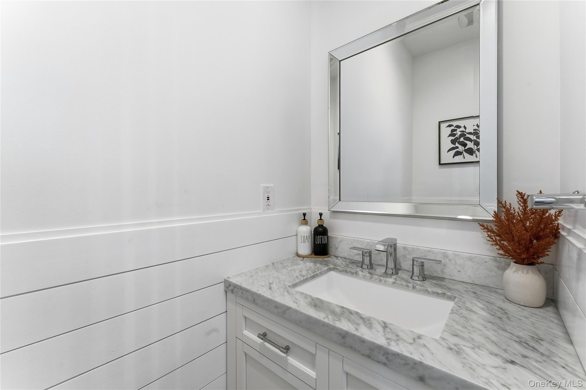 3483 Frederick Street Oceanside, NY 11572 - Photo 6 of 34 a bathroom with a granite countertop sink and a mirror