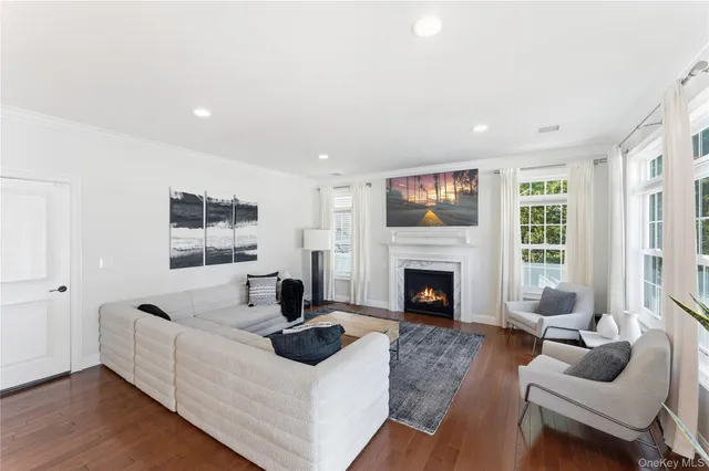 a living room with furniture a fireplace and a large window