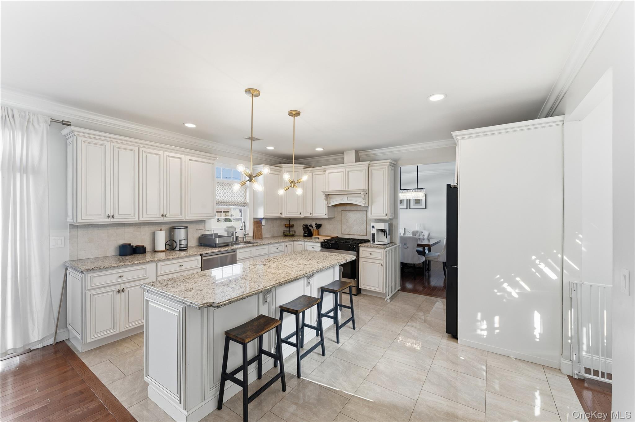 3483 Frederick Street Oceanside, NY 11572 - Photo 9 of 34 a kitchen with a sink dishwasher a refrigerator and cabinets