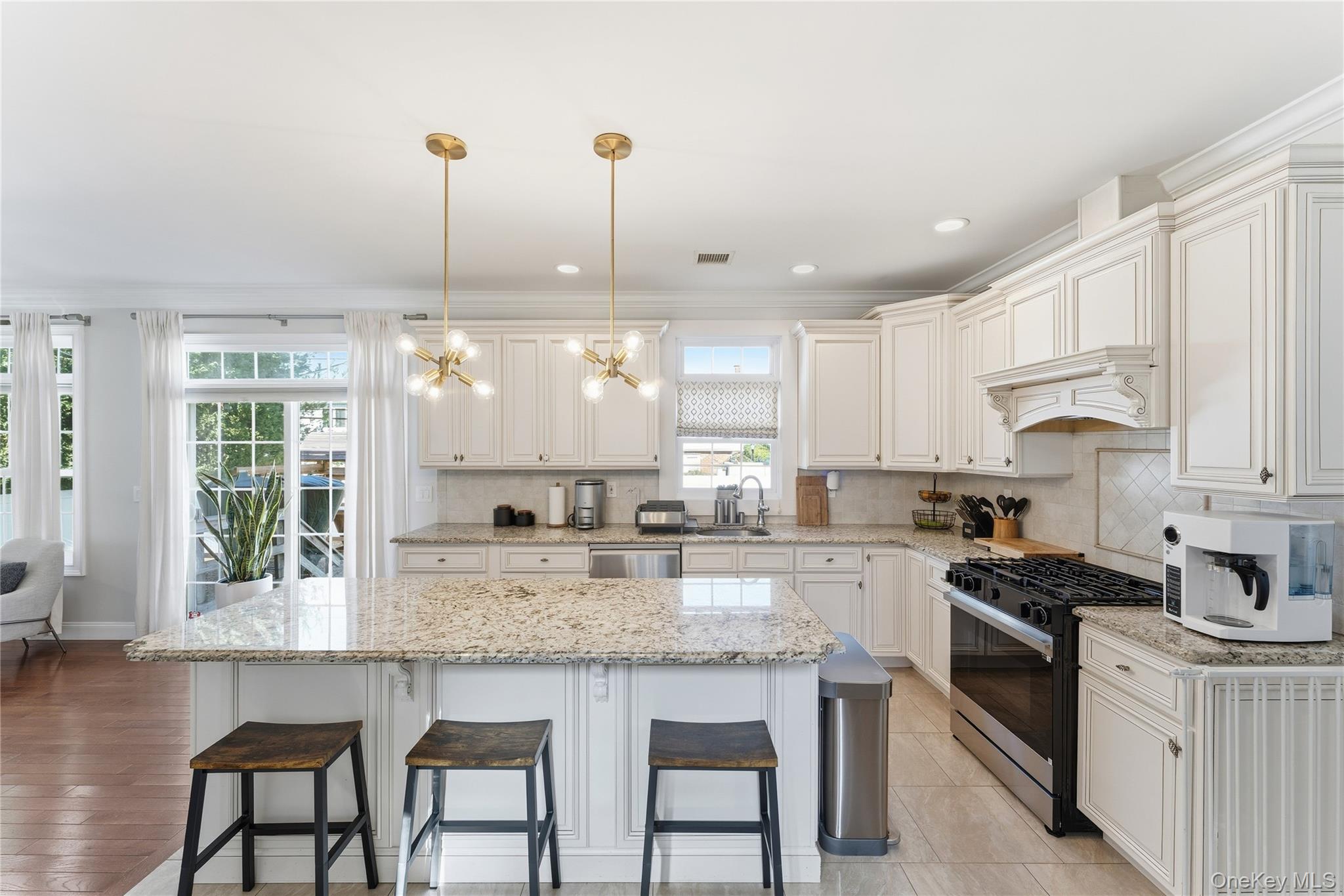 3483 Frederick Street Oceanside, NY 11572 - Photo 10 of 34 a kitchen with granite countertop white cabinets and window