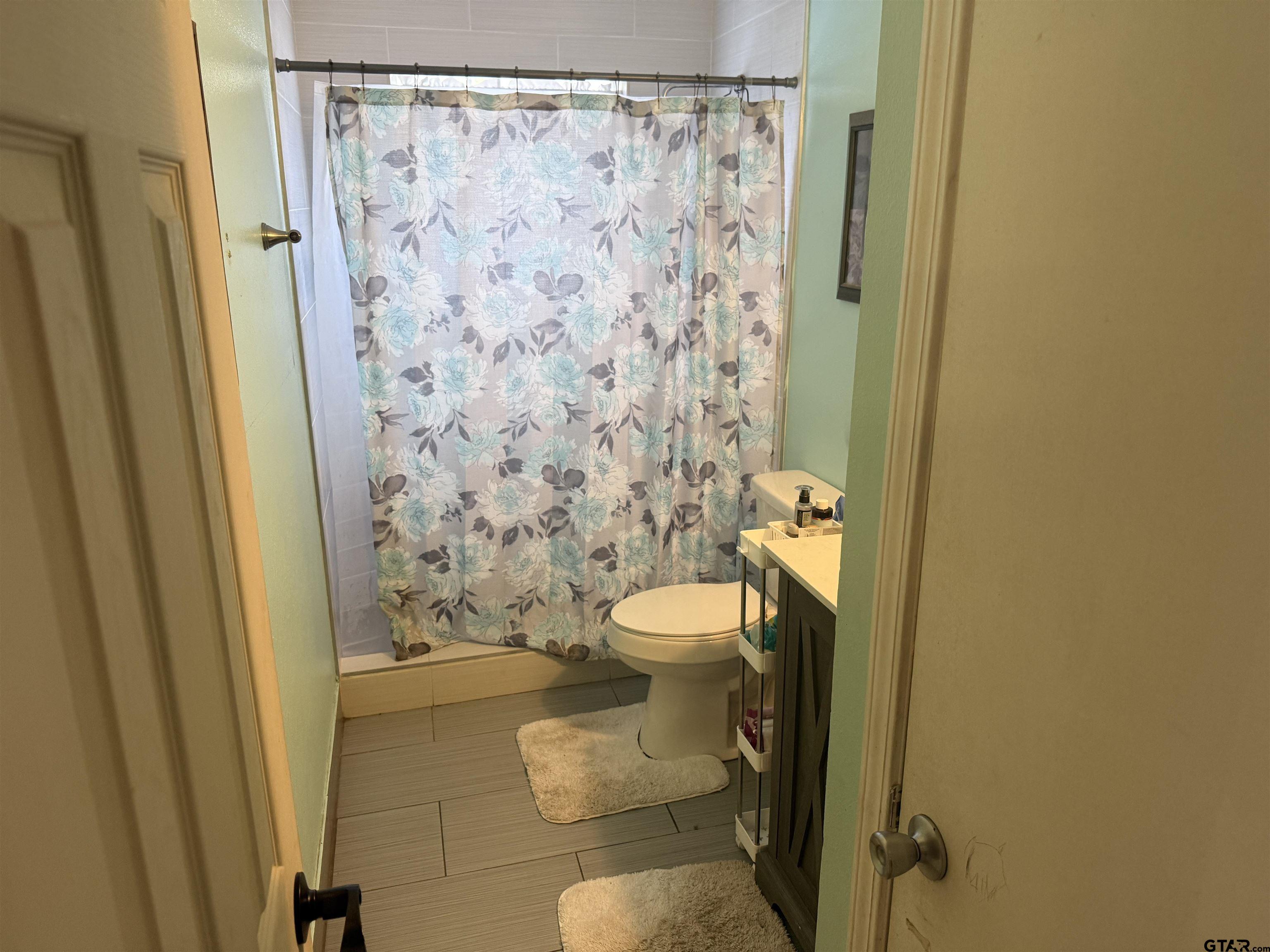 111 Jerome Court Rusk, TX 75785 - Photo 16 of 16 a bathroom with a toilet and a shower curtain